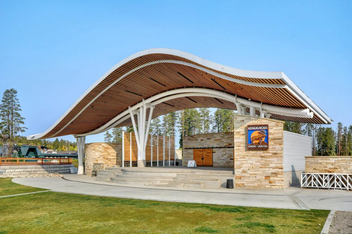 This photo showcases the iconic curved roof amphitheater at Hideaway Park, with its stone walls and open stage area ready for performances or community gatherings, highlighting a focal point of neighborhood events.